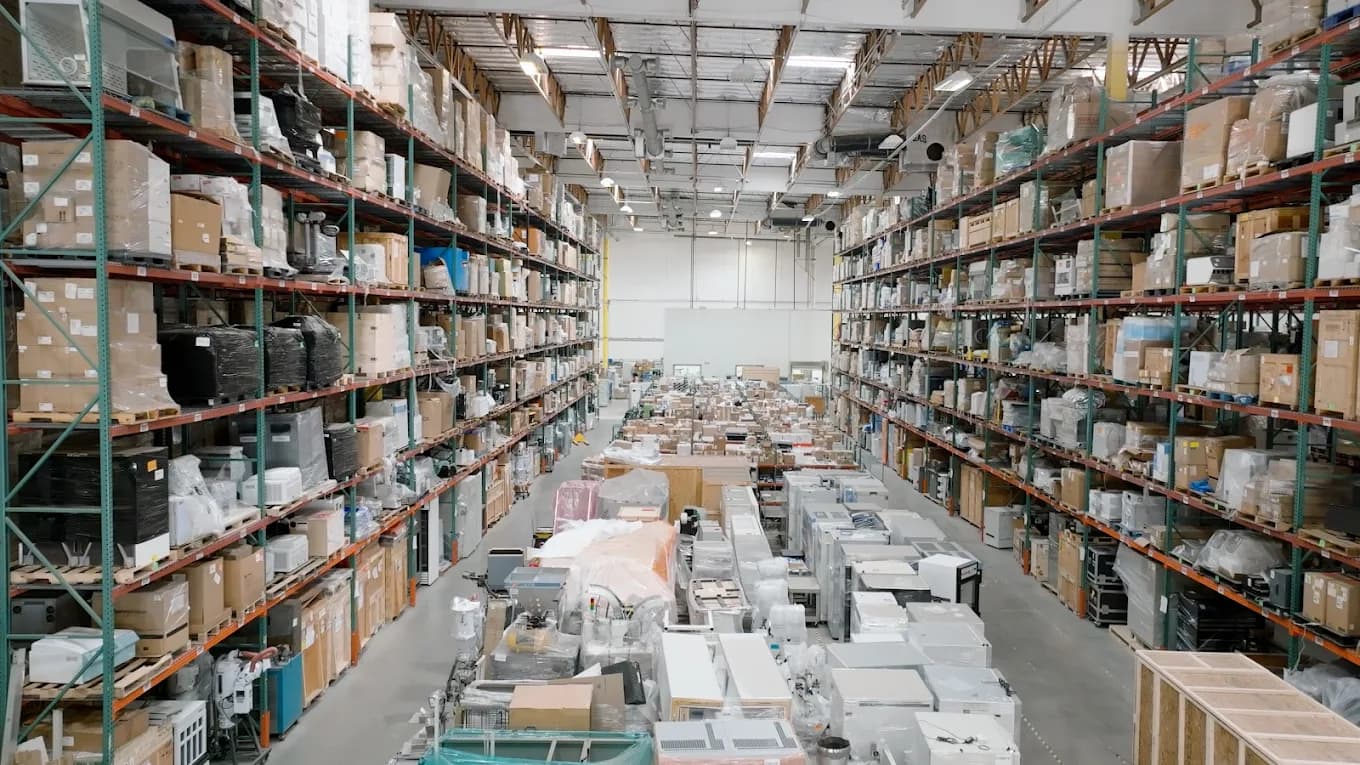 Tall warehouse racking aisles filled with palletized inventory